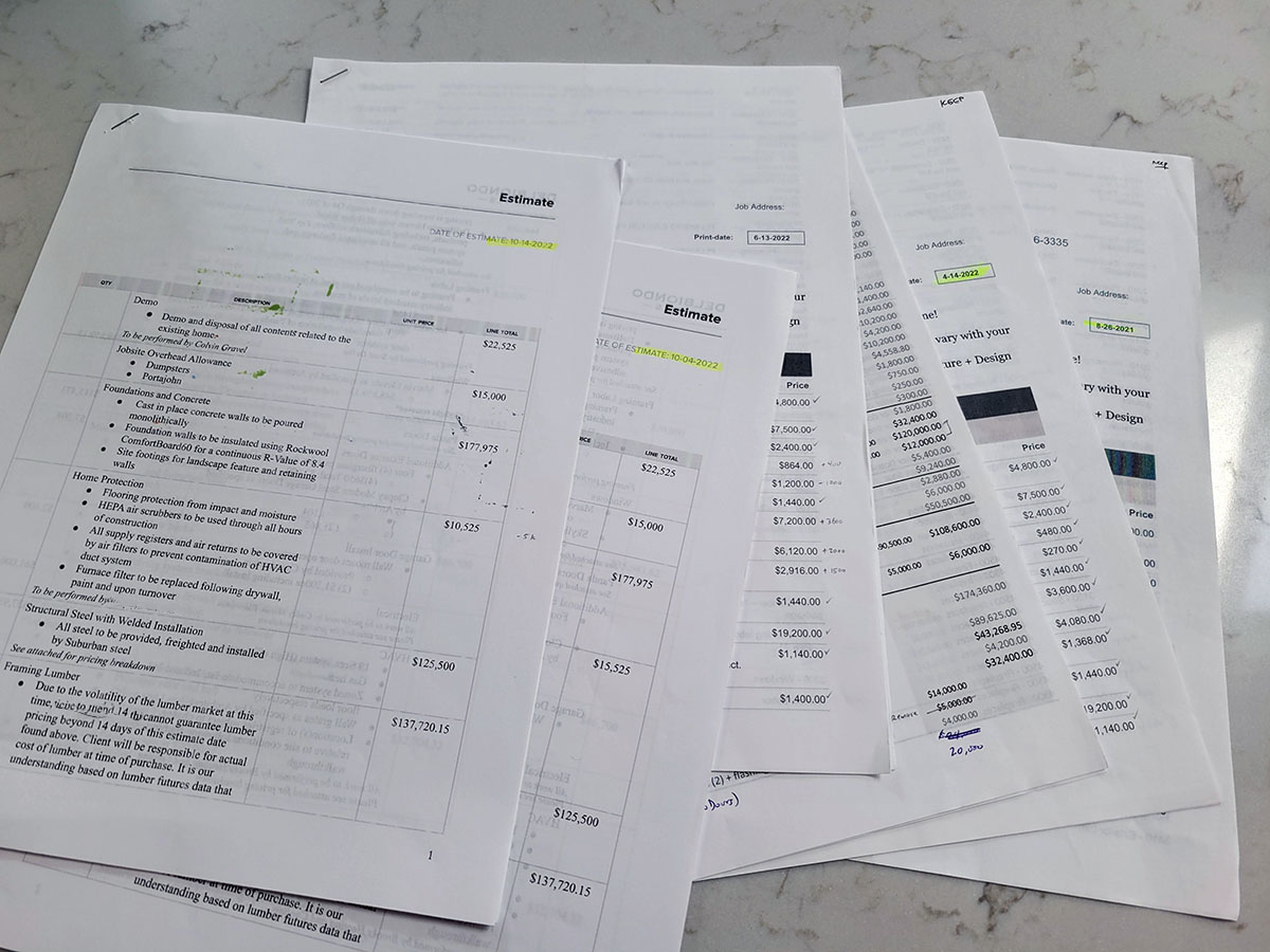 a stack of cost estimates for a custom residential project