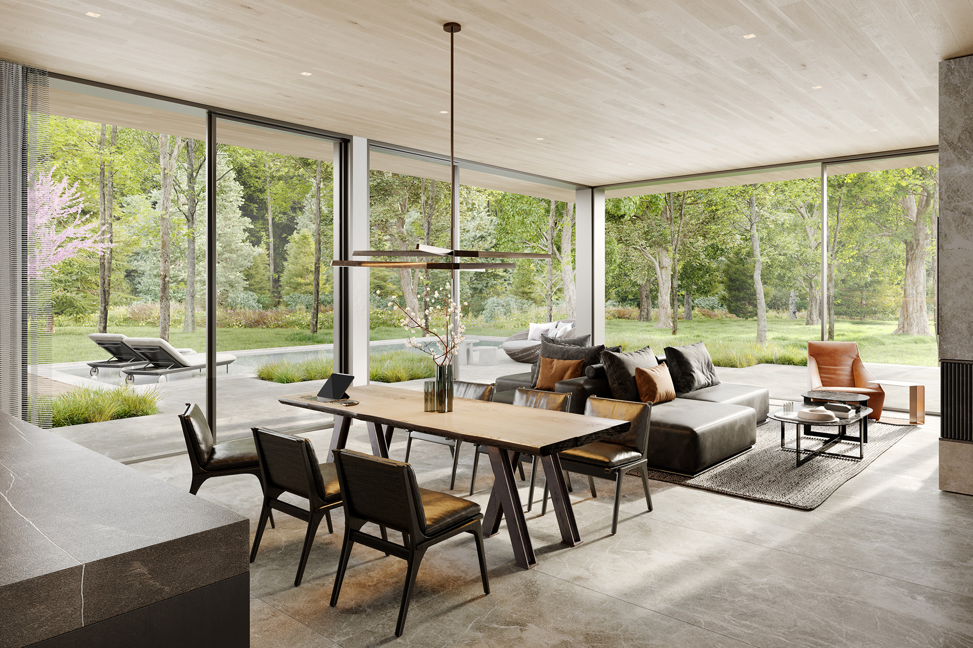 A modern industrial great room with large glass windows and doors that open to a patio with a pool and surrounded by trees